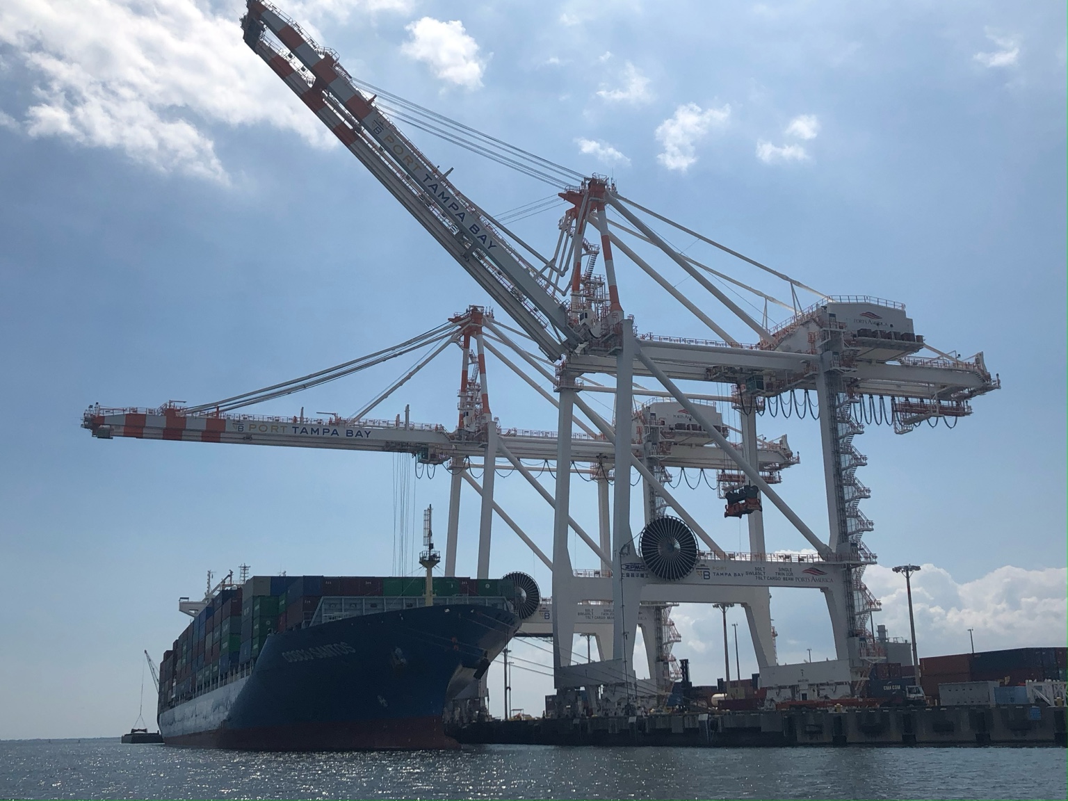 Port Tampa Bay cargo ship and container cranes representing Tampa transportation infrastructure