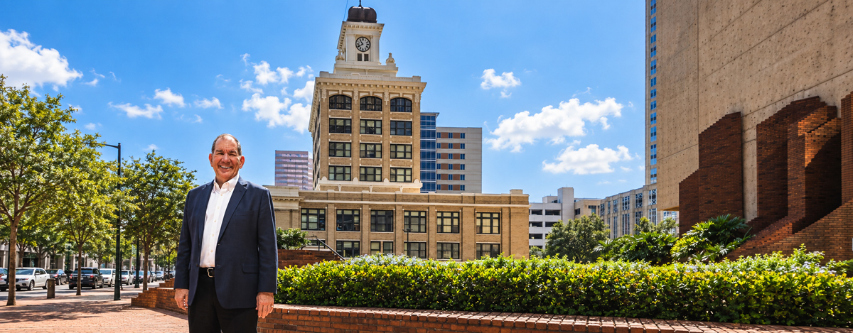 Joseph Citro standing in downtown Tampa with the historic City Hall clock tower behind him.