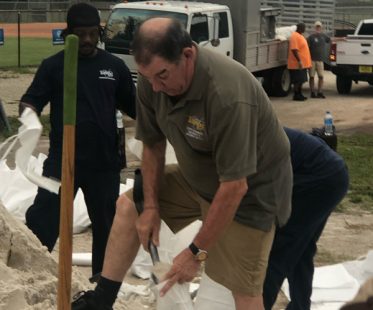 Joseph Citro volunteering alongside community members filling sandbags for storm and hurricane preparedness in Tampa.